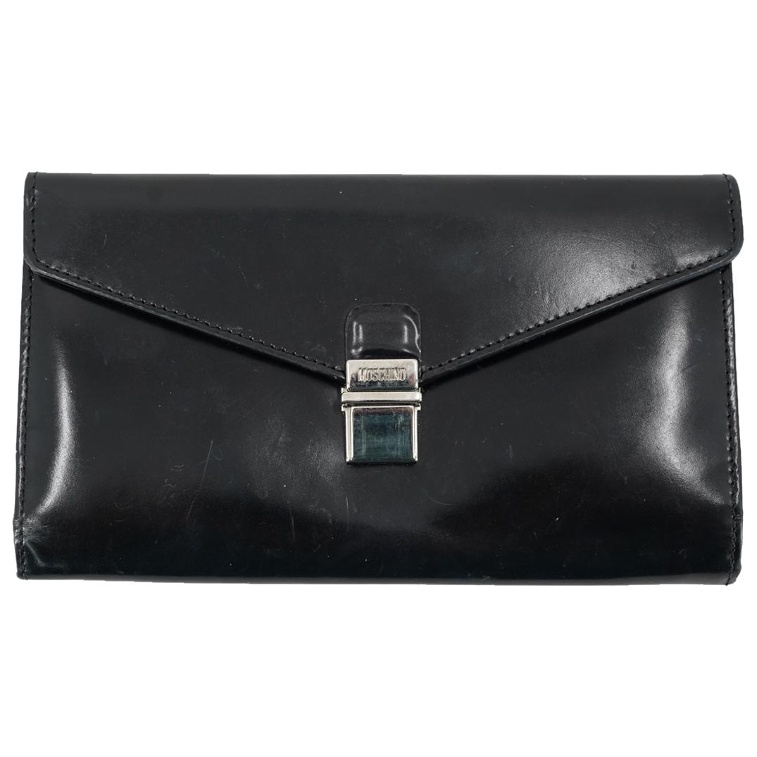 Moschino Patent Leather Wallet: DESCRIPTION: A Moschino patent leather wallet. Designed with a zippered compartment, eight card slots, and tri-fold frontal closure. With Moschino hallmark and engraved serial number 20703. CIRCA: 20t