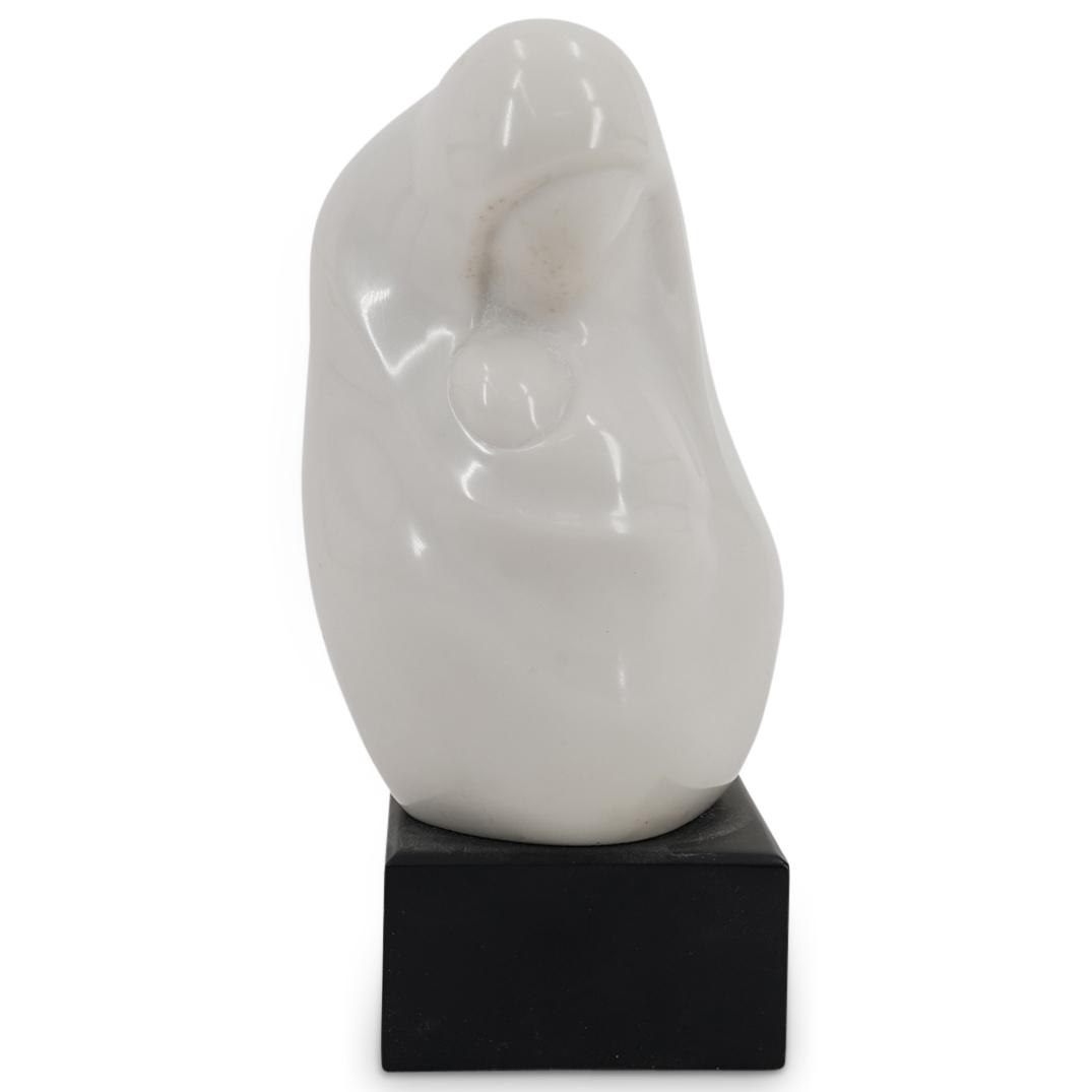Edith Kolton Minimalist Ceramic Mother & Child Sculpture: DESCRIPTION: Minimalist ceramic sculpture by artist Edith Kolton depicting in a white tone a mother holding a child. Impressed signature at the backside "SC Kolton". Mounted on a rectangular black woo