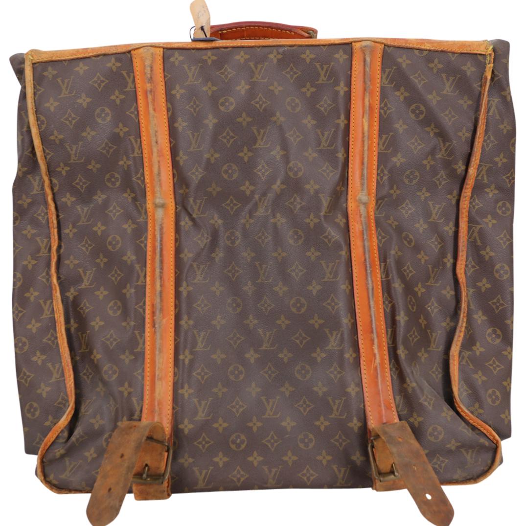 Vintage Louis Vuitton French Company Garment Bag: DESCRIPTION: A vintage Louis Vuitton French Company coated canvas garment bag luggage, featuring brown printed monogram coated canvas, brass hardware, leather trim, leather trim embellishment, and cin