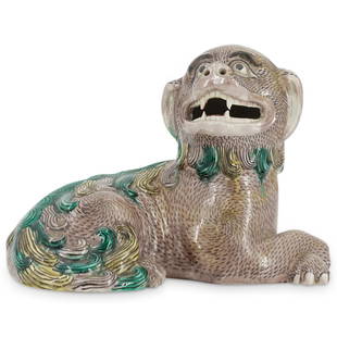 Antique Chinese Famille Verte Buddhist Lion: DESCRIPTION: An antique famille verte Buddhist lion in a reclined pose, composed of porcelain with naturalistic painted enamel and semi-gloss glazed finish. CIRCA: 19th Century Possibly older. ORIGIN: