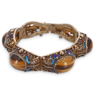 Antique Chinese Sterling & Tigers Eye Reticulated Bracelet: DESCRIPTION: Antique Chinese Sterling silver bracelet presenting gilt reticulated geometric designs throughout the six hinged links, four large tigers eye cabochons and enameled scroll designs in two