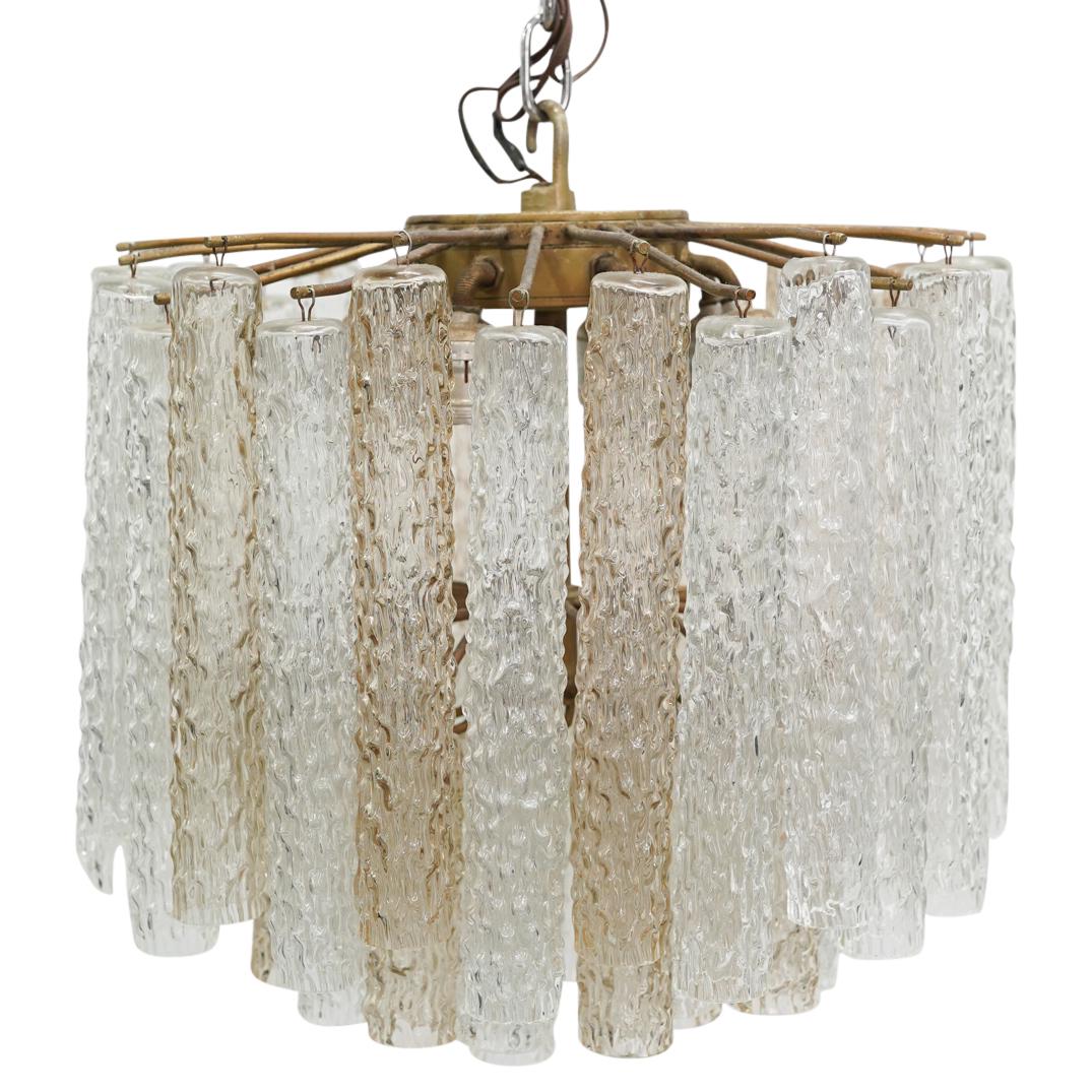 Mid Century Venini Murano Glass Chandelier: DESCRIPTION: Mid Century Venini Murano glass chandelier featuring three tiered round arrays of ribbed cylindrical clear glass crystals, with the top tier presenting longer crystals. and nine light soc
