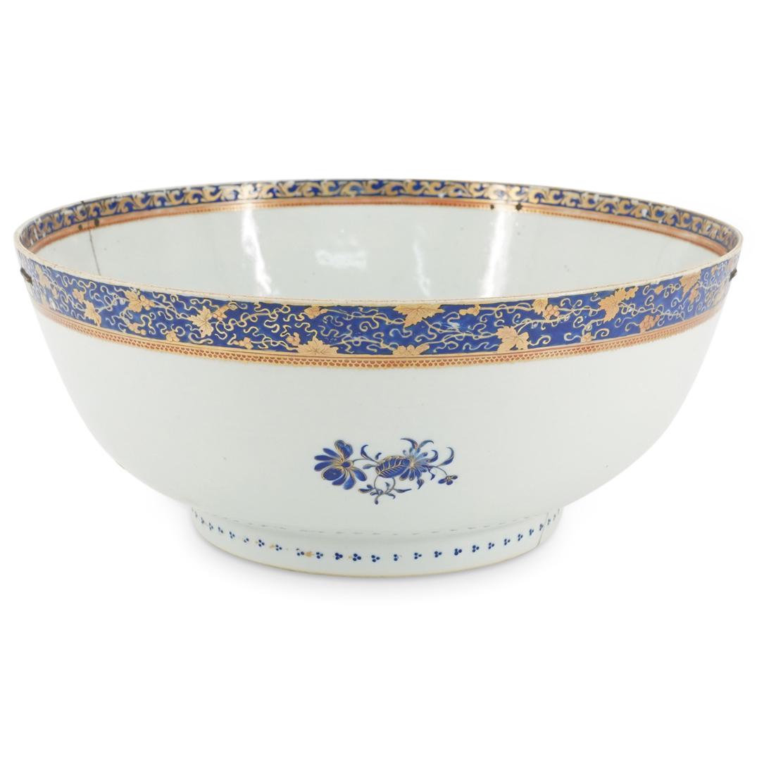 18th Century Chinese Export Porcelain Bowl: DESCRIPTION: Chinese porcelain bowl featuring a blue floral motifs in well and on sides. Piece is embellished with gilt accents and gilt foliage patterns on rim. CIRCA: 18th Century ORIGIN: China DIME