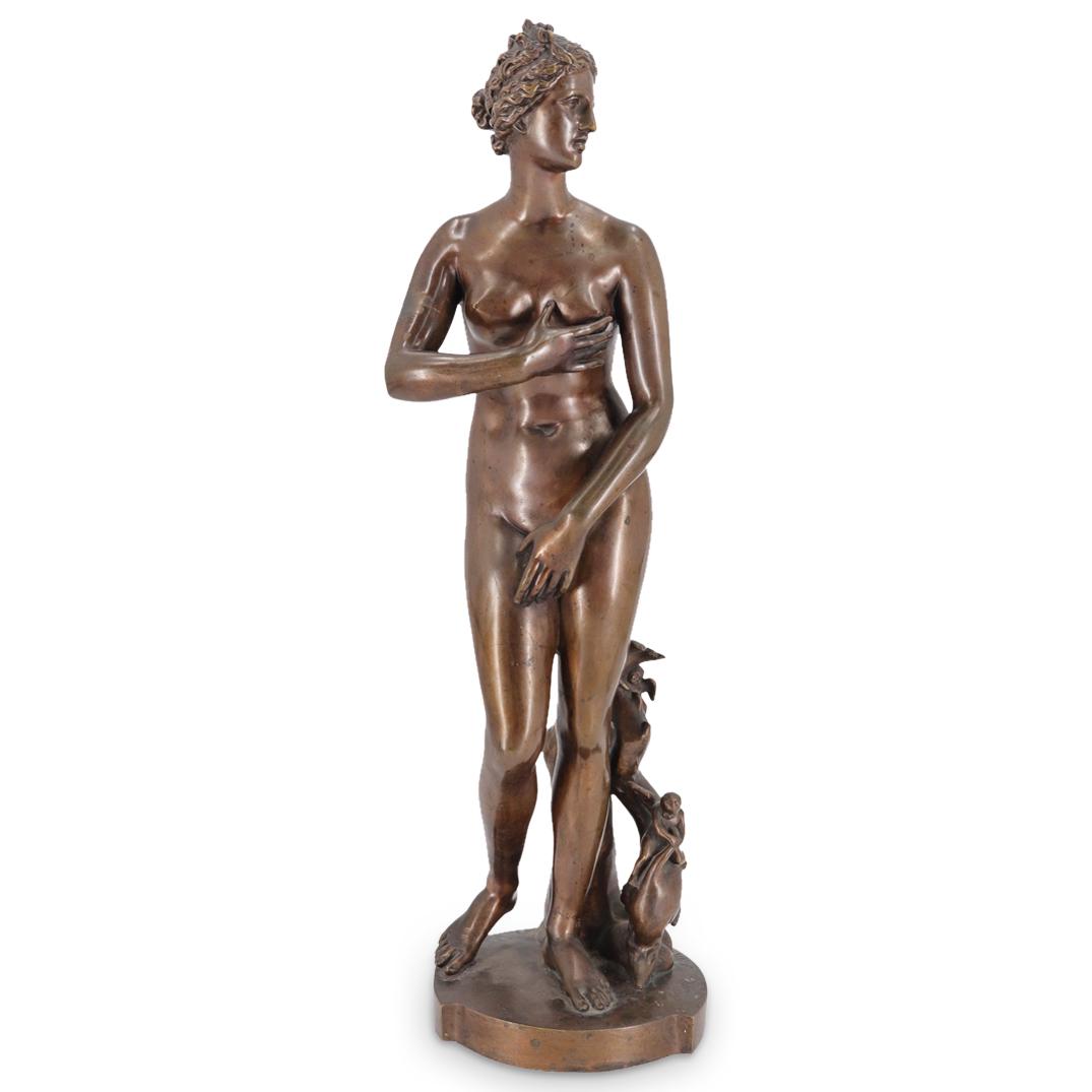 Auguste Moreau (1860-1910) Bronze Venus De Medici: DESCRIPTION: Bronze sculpture by Auguste Moreau after the Venus de Medici depicting Aphrodite standing next to a tree stump populated by puttos. Piece is signed adjacent to stump. CIRCA: Late 19th to
