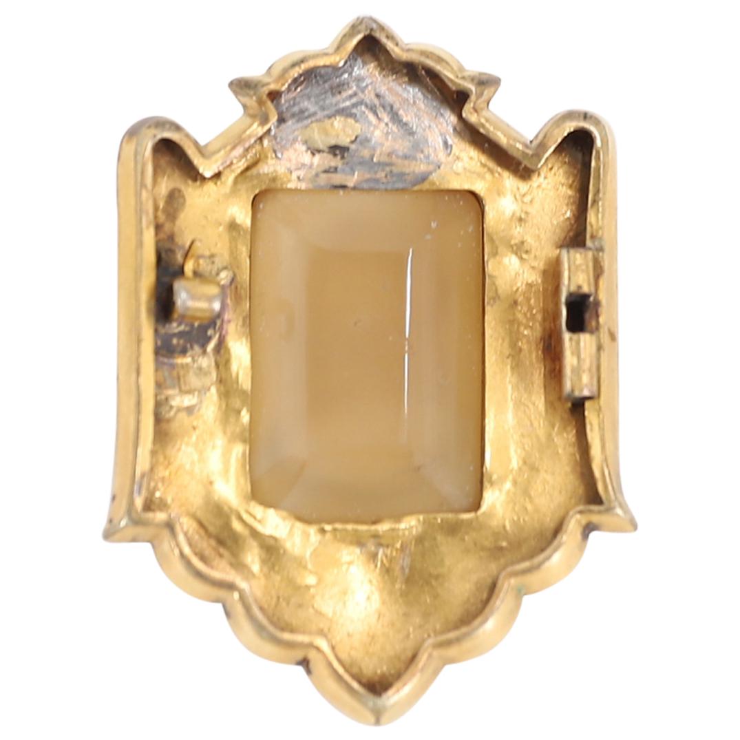 Antique Italian Carved Agate Intaglio Cameo In Gilt Frame: DESCRIPTION: Carved agate intaglio cameo depicting an image in relief of a bearded man crowned with a laurel wreath. Piece is set into a gilt metal frame decorated with floral, foliage, and geometric 