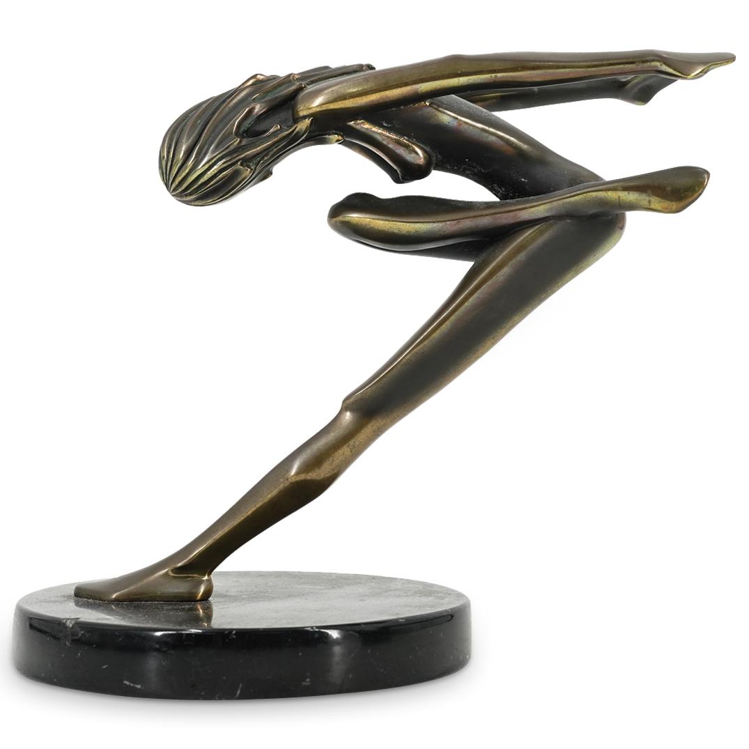 Tom Bennett (B. 1928) Gilt Bronze Nude Dancer Sculpture: DESCRIPTION: Gilt bronze sculpture by Tom Bennett depicting a nude dancer in a dramatic motion. Piece is mounted on a black, hard stone base. Signed on sole of right foot and numbered 29 of 100. CIRCA
