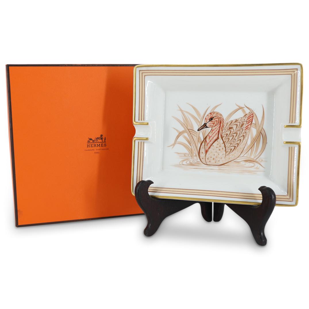 Hermes Porcelain Duck Ashtray / Vide Poche: DESCRIPTION: A Hermes porcelain rectangular ashtray / vide poche. Decorated with a painting of a duck swimming among rushes. Marked with Hermes and Made in France hallmarks. CIRCA: 20th Century ORIGIN