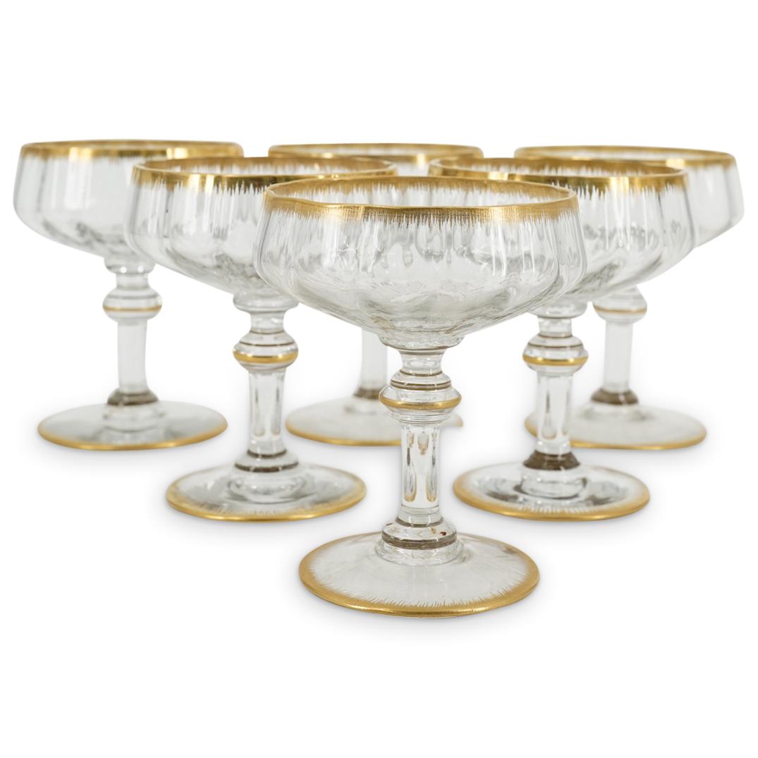 (6 Pc) Daum Nancy Ribbed Vintage Sparkling Wine Glasses: DESCRIPTION: Six Daum Nancy vintage sparkling wine glasses, each featuring a ribbed bowl and decorated with gilt accents around the lip, stem, and foot. Each piece is marked on underside "DAUM NANCY F