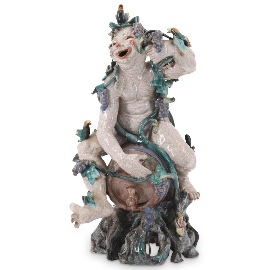 Leopold Anzengruber (Austrian, 1912-1979) Bacchus Ceramic Sculpture: DESCRIPTION: Colorfully glazed ceramic sculpture by Viennese artist Leopold Anzengruber (1912-1979); Depicting Bacchus smiling while seated nude atop a barrel, holding a goblet in his left hand and wr