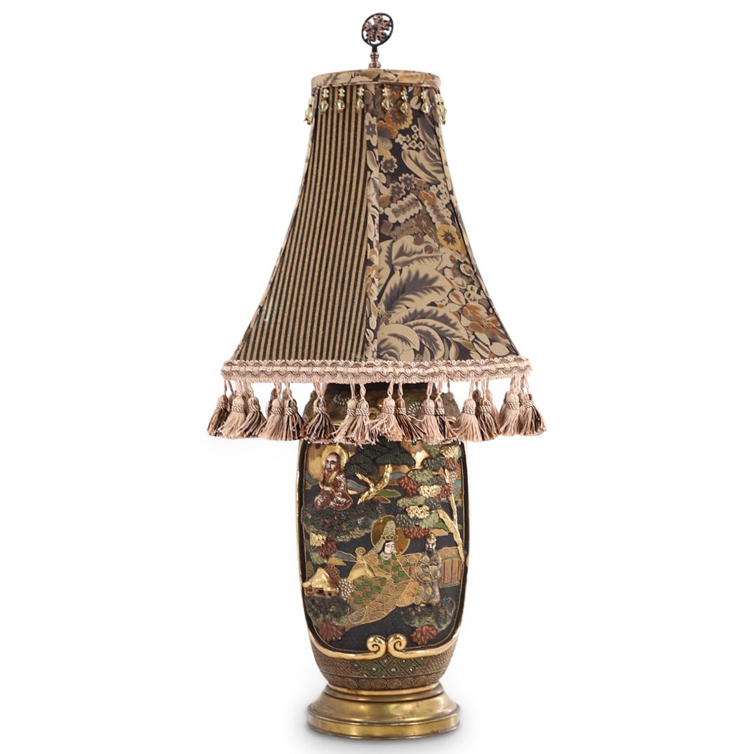 Antique Japanese Satsuma Vase Lamp: DESCRIPTION: Antique Japanese Satsuma vase lamp presenting landscape depictions in high relief with haloed buddhist figures, trees, city and gilt accents throughout. The lampshade is composed of gold 