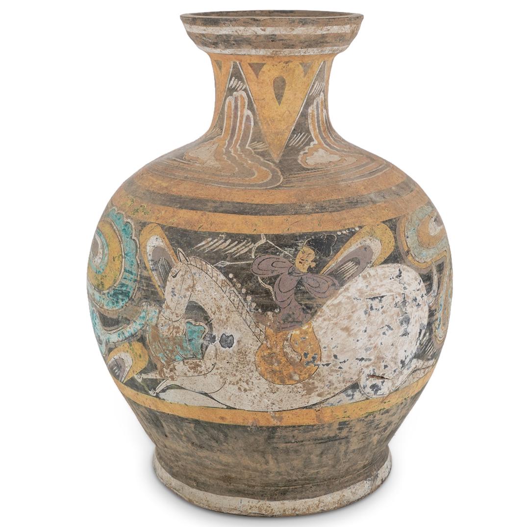 Ancient Chinese Western Han Dynasty Earthenware Hu Vase: DESCRIPTION: Ancient Western Han period hu shaped earthenware wine vessel featuring an alternating triangle pattern around the neck. Piece is decorated with an image of an archer on horseback among ai