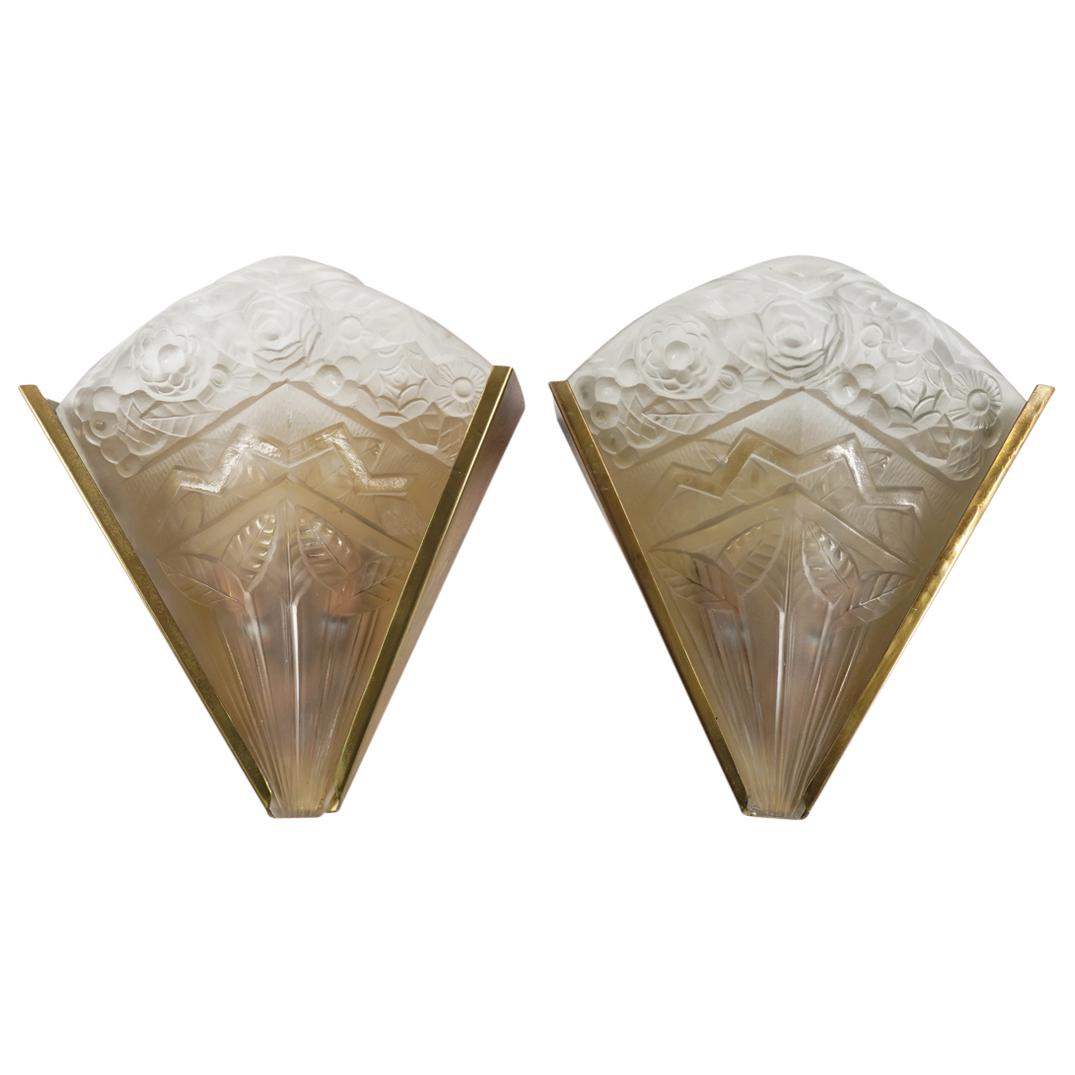 Jean Noverdy France Art Deco Sconces: DESCRIPTION: Jean Noverdy France Art Deco molded glass floral sconces with gold toned metal brackets and molded floral motif glass sconces inserts. Fitted with double light sockets, glass shades signe