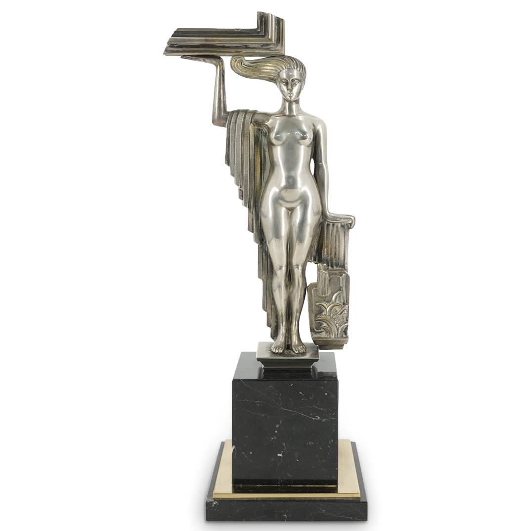 Art Deco Silvered Bronze Figural Statue: DESCRIPTION: French Art Deco silvered bronze figural statue depicting a nude women uplifting architectural column details, mounted to a black marble bases with gilt bronze accents. CIRCA: Early 20th C