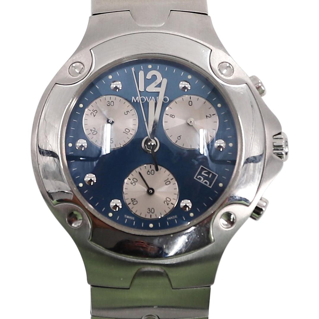 Movado Sports Edition Chronograph Stainless Watch: DESCRIPTION: Movado stainless quartz watch, chronograph, blue dial, analog display, silvered hands and markers. With a stainless steel bracelet. Marked along the back with case number "618612". CIRCA: