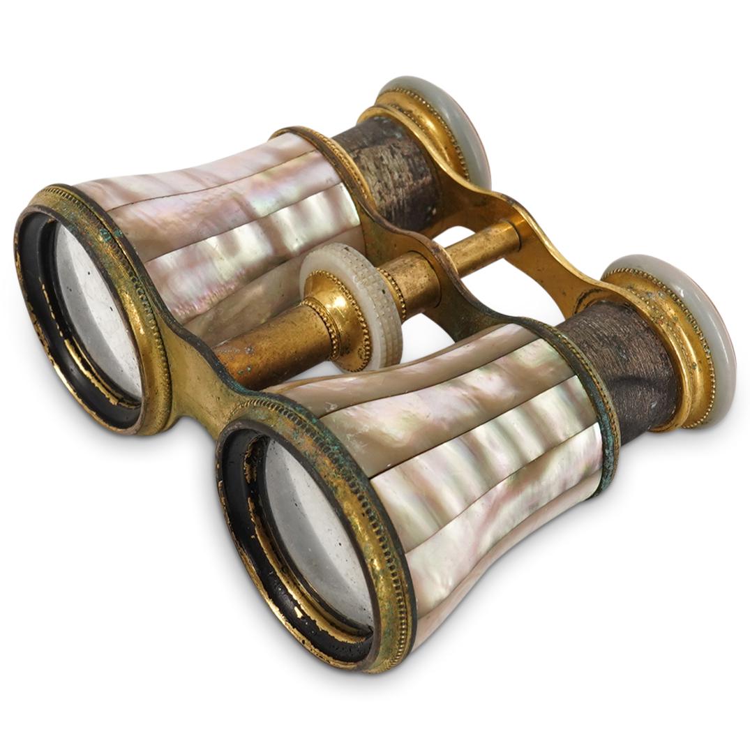 Pair Of French Lemaire Bronze And Mother Of Pearl Opera Glasses: DESCRIPTION: Pair of Lemaire opera glasses featuring a gilt bronze casing and components adorned with mother-of-pearl slats and trimmings. Marked "LeMaire Ft Paris" on viewing side of lenses. CIRCA: E