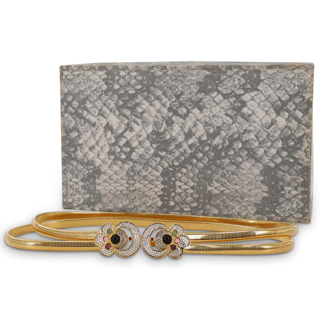Judith Leiber Jeweled Gold Tone Metallic Waist Belt: DESCRIPTION: A Judith Leiber gold tone metallic waist belt with jeweled clasp closure further embellished with faux diamond Swarovski crystals. With original Judith Leiber box. CIRCA: 20th Century DIM