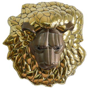 Sergio Bustamante (Mexican, 1934â€“2014) "King of the Jungle" Metal Wall Sculpture: DESCRIPTION: Mixed metal wall sculpture by renowned Mexican artist Sergio Bustamante (1934-2014) titled "King of the Jungle"; Depicting a lions face in bronze toned metal surrounded by a wavy mane