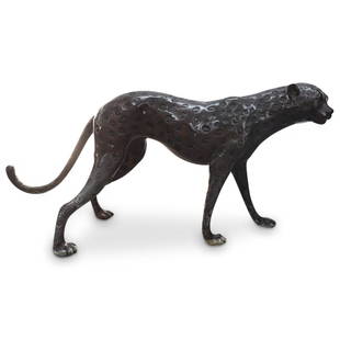 Hollywood Regency Bronze Cheetah Sculpture: DESCRIPTION: Large Hollywood Regency bronze sculpture depicting a cheetah featuring indented spots, details of a curling tail, claws at the paws, facial features and round ears. CIRCA: Mid 20th Centur