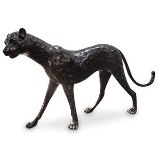 Hollywood Regency Bronze Cheetah Sculpture: DESCRIPTION: Large Hollywood Regency bronze sculpture depicting a cheetah featuring indented spots, details of a curling tail, claws at the paws, facial features and round ears. CIRCA: Mid 20th