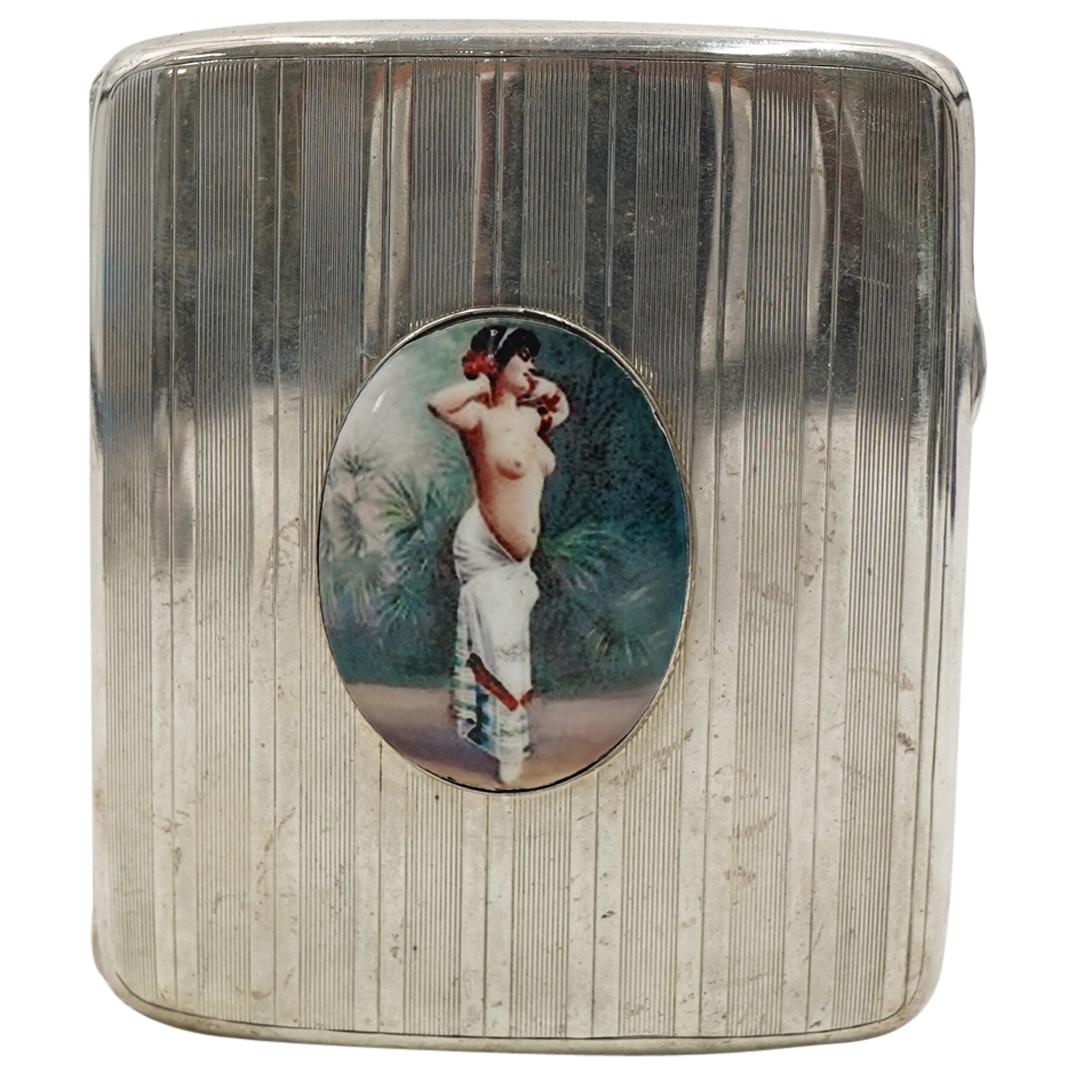 Antique A&J Zimmerman Enameled Nude Sterling Cigarette Case: DESCRIPTION: Antique A and J Zimmerman Sterling silver cigarette case featuring an oval plaque polychrome enameled with a depiction of a semi nude woman standing among foliage, bands of stripes throug