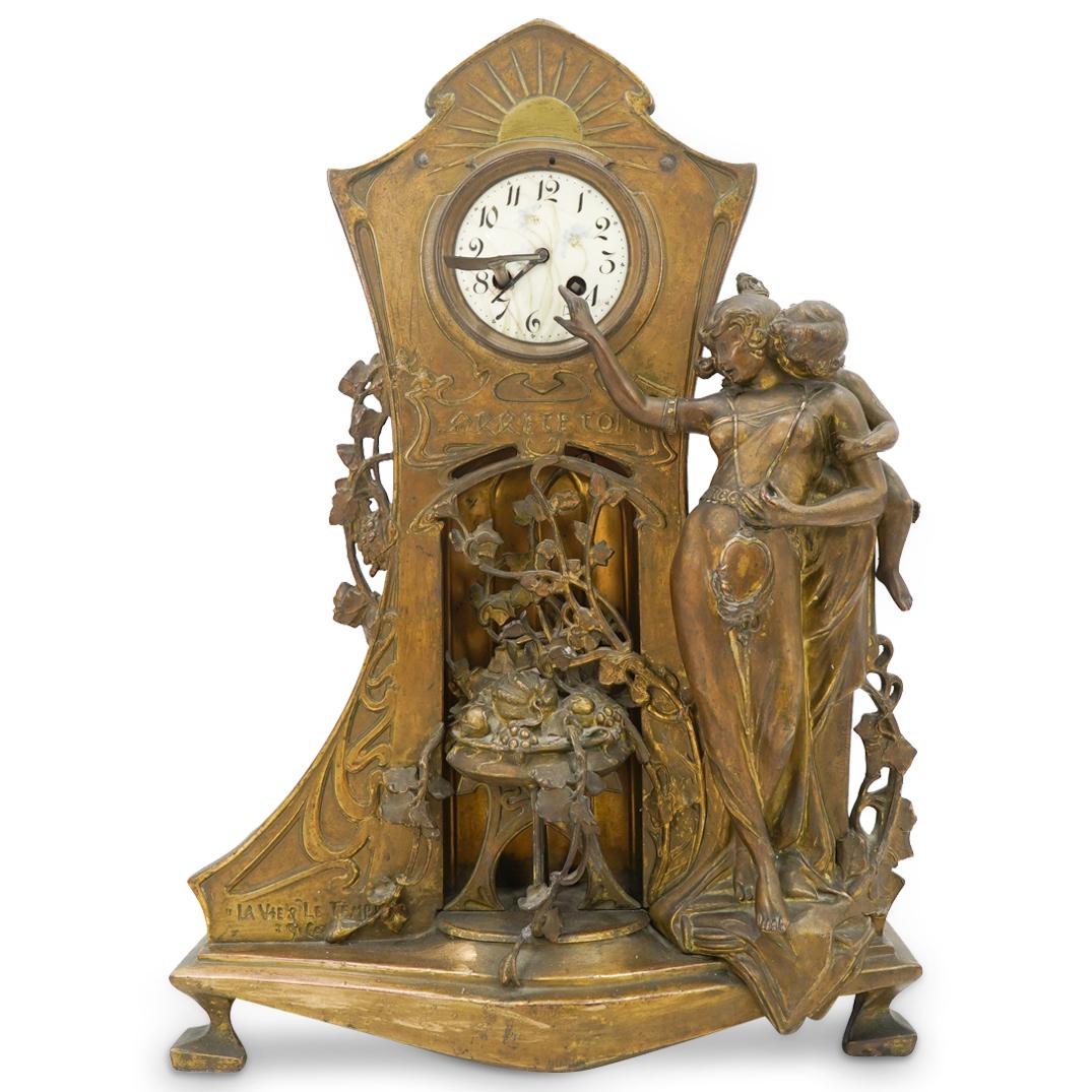 French Art Nouveau Spelter Mantel Clock: DESCRIPTION: A 19th Century French Art Nouveau La Vie & Le Temp spelter pendulum shelf clock decorated with embossed stylized motifs in the Art Nouveau style; further embellished with a figural motif 