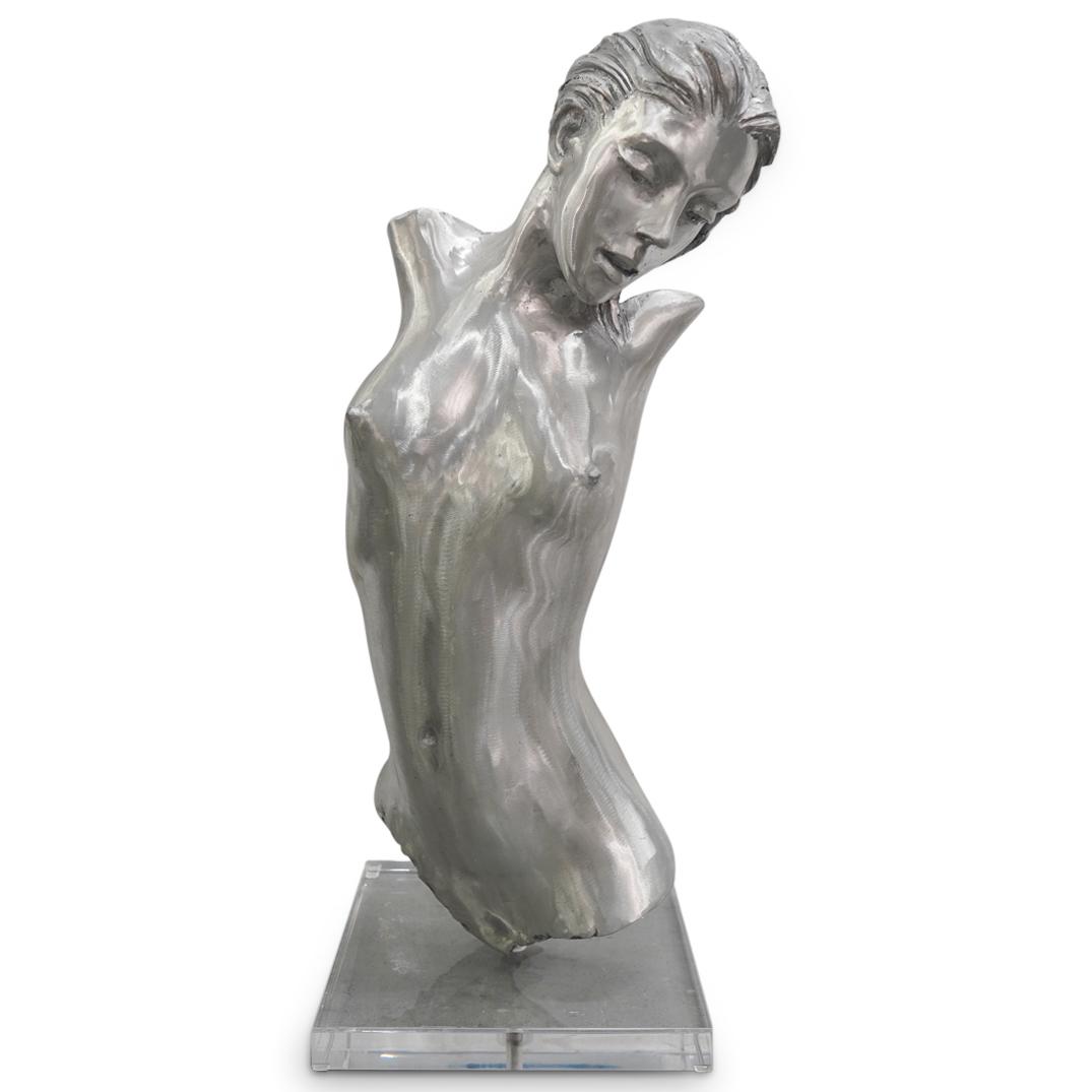 Large Female Nude Torso Aluminum Sculpture: DESCRIPTION: A large female nude torso sculpture in aluminum over a square clear acrylic lucite base, depicting a nude torso bust and face of a female figure in a suggestive dynamic pose. CIRCA: 20th