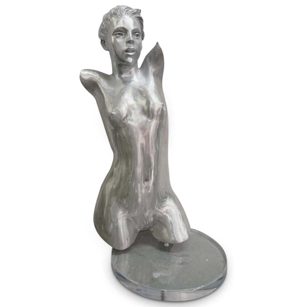 Large Female Nude Torso Aluminum Sculpture: DESCRIPTION: A large female nude torso sculpture in aluminum over a circular clear acrylic lucite base, depicting a nude torso bust and face of a female figure in a suggestive dynamic pose. CIRCA: 20t