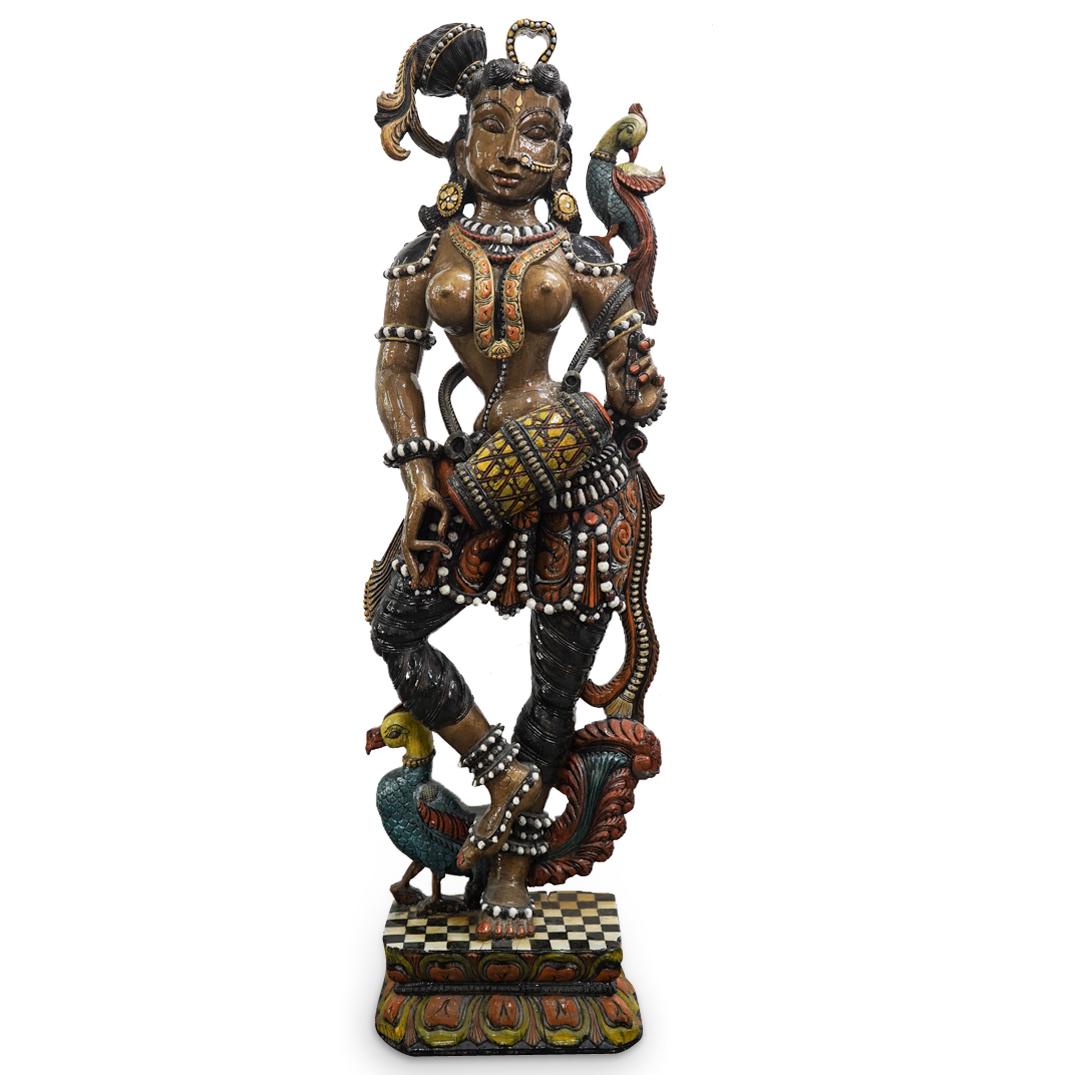 Lacquered Wood Nude Hindu Deity Sculpture: DESCRIPTION: Carved wood Hindu sculpture of a semi nude goddess atop checkered lotus base completed with a polychrome glossy lacquer and depicted standing with a bird on her left shoulder, a drum in h