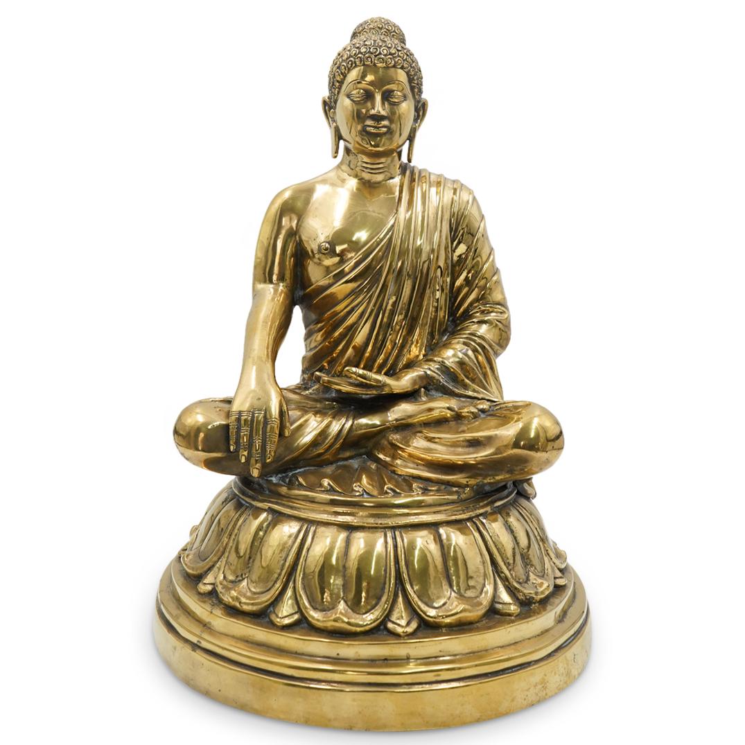Parcel Gilt Metal Buddha Sculpture: DESCRIPTION: Parcel gilt metal sculpture of a seated buddha, meditating atop a lotus throne and wearing robes. CIRCA: 20th Century ORIGIN: Continental DIMENSIONS: H: 22.5" D: 14" Have a similar item t