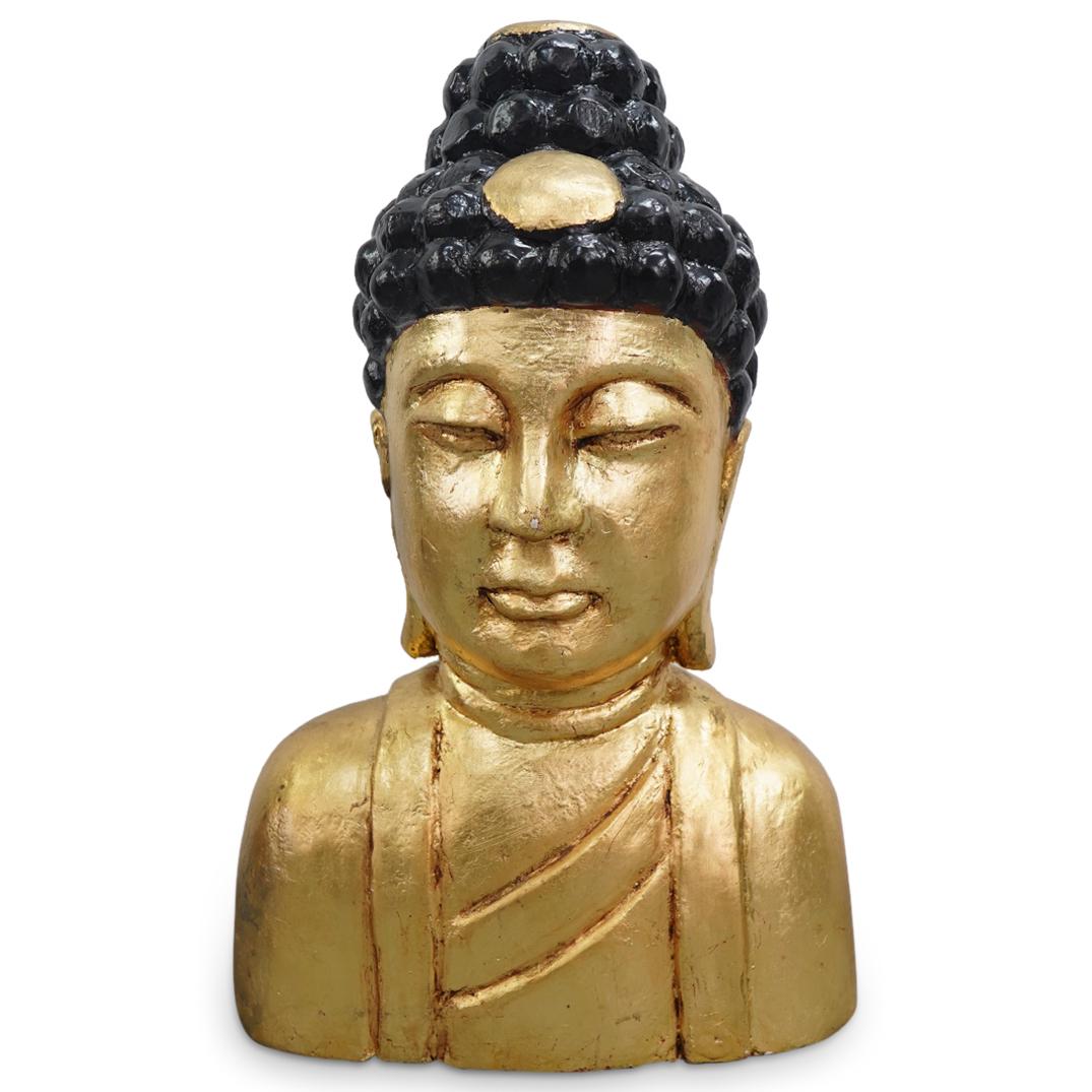 Large Chinese Carved Wood Gilt And Black Gautama Buddha Bust: DESCRIPTION: Carved wooden bust of Gautama Buddha depicting him with half-open eyes, long earlobes, and a gilt crest and ushnisha (top knot) among his ebony curls. Figure is gilt everywhere except the