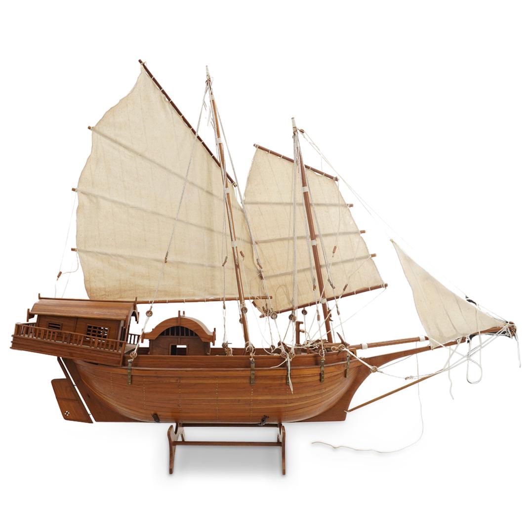 Chinese Carved Wood Model Chuan Boat: DESCRIPTION: Carved wood model of a Chinese chuan ("junk") featuring cloth sails, block and tackle, and two cabins toward the stern. Includes a wood display stand. CIRCA: 20th Century ORIGIN: China DI