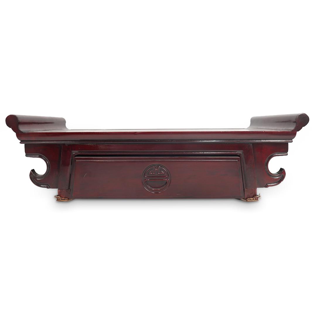 Chinese Polished Carved Wood Altar Stand With Drawer: DESCRIPTION: Carved wood altar stand featuring a drawer marked with a Shou ("longevity") mark and a raised end on either side. Piece is embellished with a horned accent on either side of the drawer. C