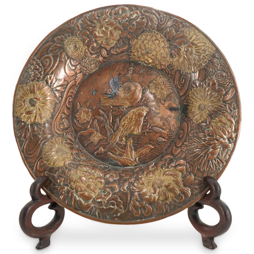 Antique Japanese Meiji Period Mixed Metal Songbird Dish: DESCRIPTION: Meiji period mixed metal saucer decorated on rim with floral, foliage, and cloud designs in low relief and with floral, foliage, and bird designs in well. CIRCA: 19th Century ORIGIN: Japa