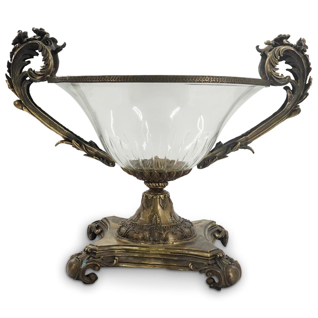 Mark Roberts Mixed Metal & Glass Ornamental Centerpiece: DESCRIPTION: A Mark Roberts mixed metal and glass ornamental centerpiece, designed with a square footed metal base with an antique patina finish; and a circular clear glass centerpiece vase surmounted