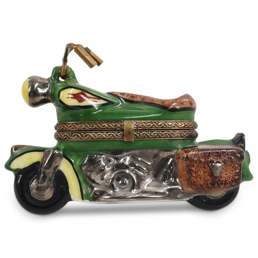 La Gloriette Limoges Porcelain "Motorcycle" Trinket Box: DESCRIPTION: A Limoges porcelain trinket box depicting a motorcycle. Marked with "La Gloriette Limoges France" hallmarks on the underside. CIRCA: 20th Century ORIGIN: France DIMENSIONS: L: 3" Have a s