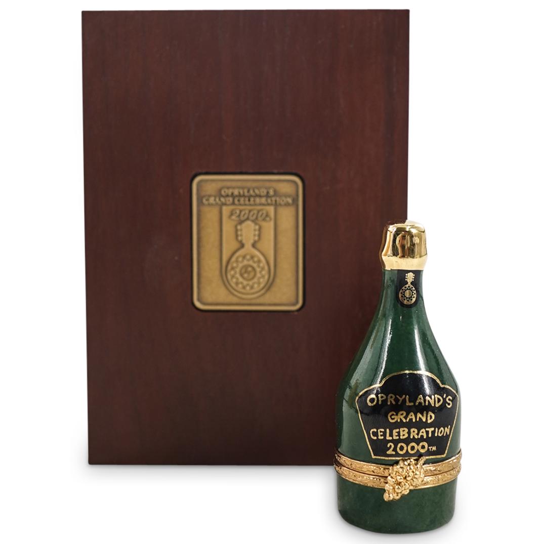 Artoria Limoges Porcelain "2000 Oprylands Grand Celebration" Trinket Box: DESCRIPTION: Artoria Limoges limited edition "2000 Oprylands Grand Celebration" porcelain trinket box depicting a bottle of champagne, with label that reads "2000 Oprylands Grand Celebration". Marked 