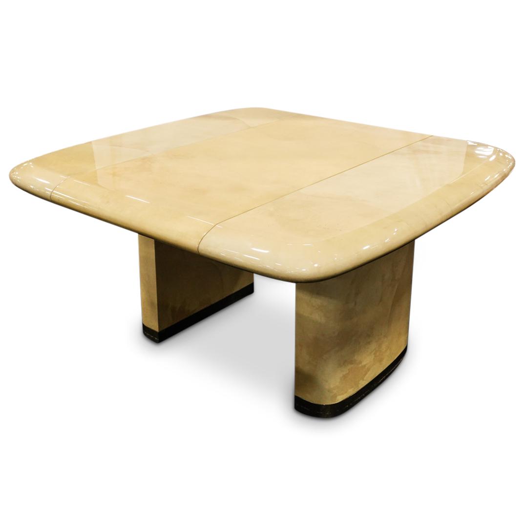 Ron Seff "Cushion Shaped" Dining Table: DESCRIPTION: Ron Seff "Cushion Shaped Dining Table" featuring a lacquered goatskin with brass sabots. Extends to allow further leaves. CIRCA: 1980s ORIGIN: USA DIMENSIONS: H: 29" x W: 53" x L: 53.5" I