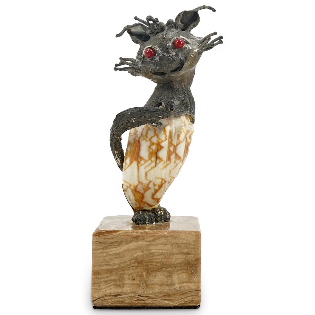 Aurelio Teno (Spanish, 1927-2013) Shell and Silver Cat Sculpture: DESCRIPTION: Sculpture by Aurelio Teno depicting a cat fashioned out of a shell torso surrounded by a silver body, head, and tail and finished with enamel eyes. Cat is playing with his tail and grinni