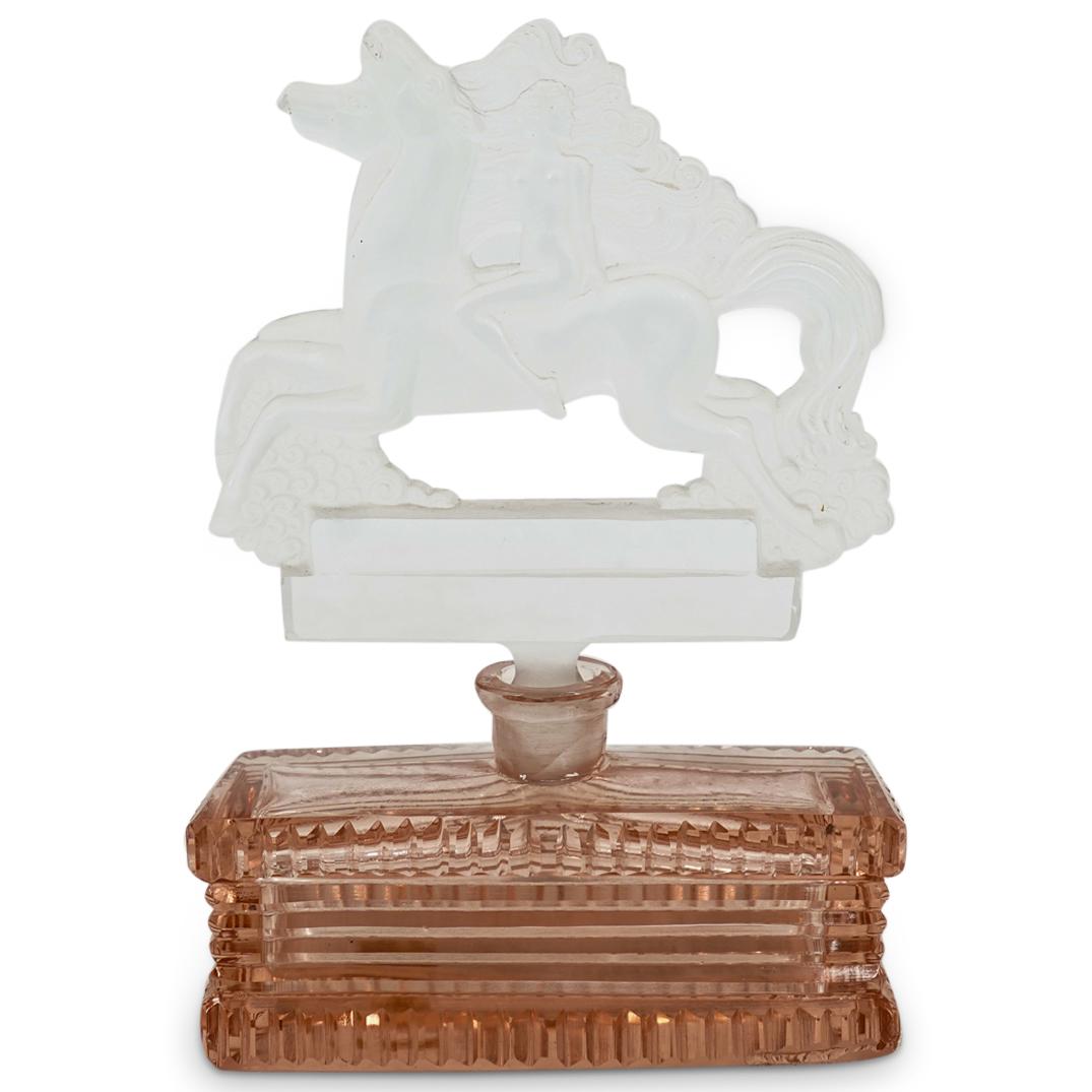 Antique Czech Intaglio Glass Perfume Bottle: DESCRIPTION: Antique Czech perfume bottle featuring a frosted glass stopper with an intaglio cut depiction of a nude woman riding a horse alongside another horse, and a rectangular translucent pink bo