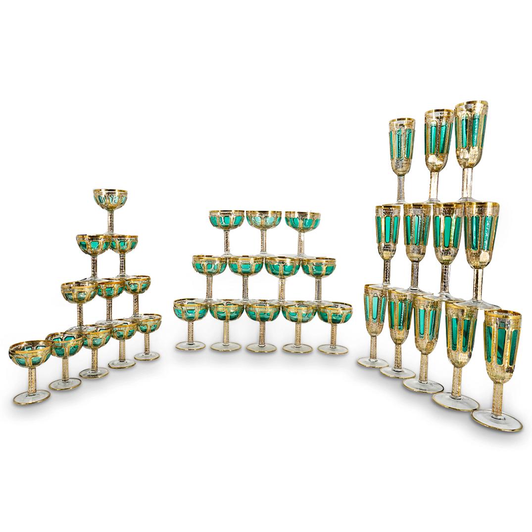 (35 Pc) Moser Green Faceted And Gilt Trim Drinking Glasses: DESCRIPTION: Set of 35 pieces of Moser glass including wine glasses, sherry glasses, and champagne flutes. Each piece is decorated with green facets and embellished with gilt accents around the lip, b