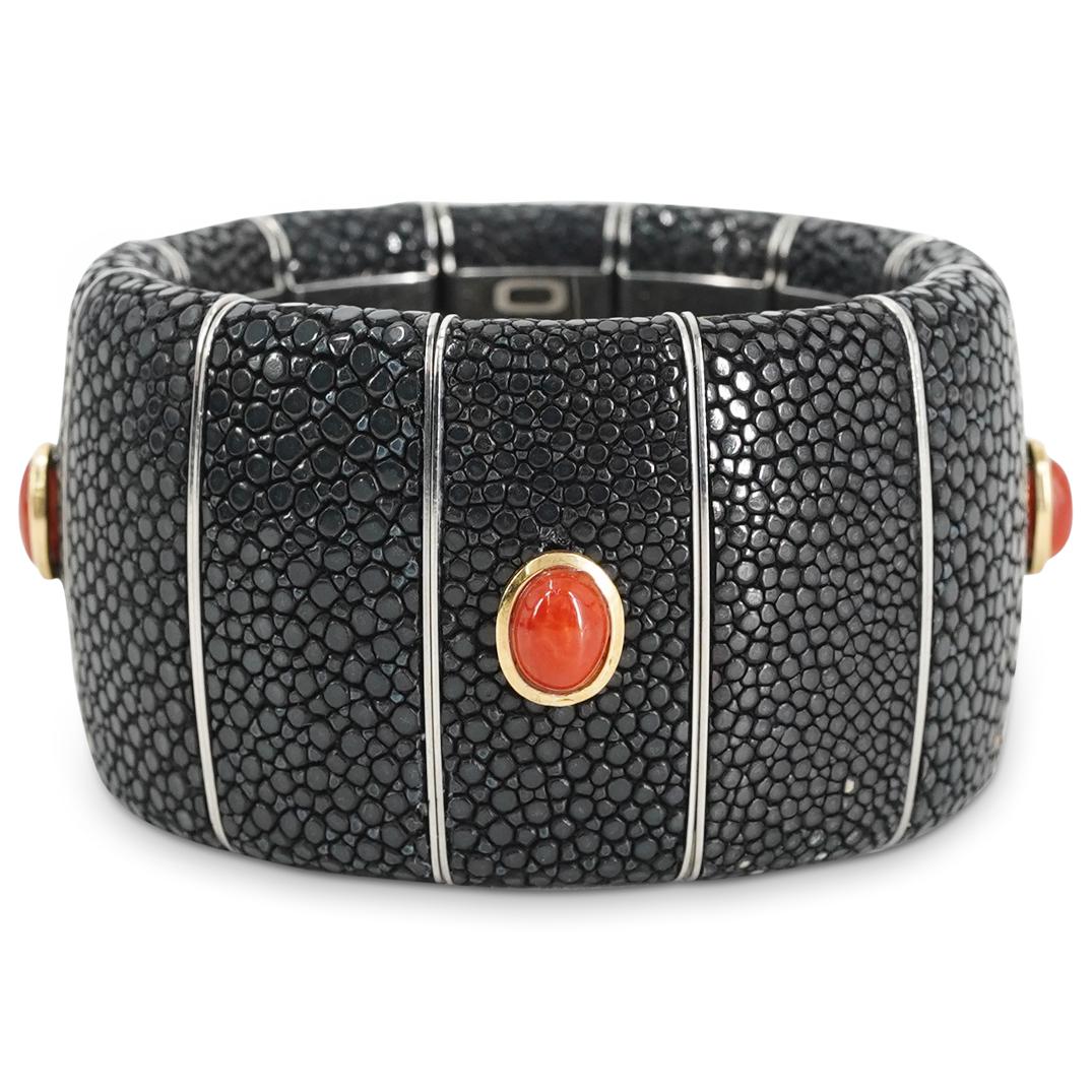 Liverino Shagreen and Gold Mounted Coral Bracelet: DESCRIPTION: A Liverino expandable bracelet crafted by shagreen body decorated with a series of gold mounted Coral cabochons. Marked along the inner band "Liverino" The famous company Liverino was fou
