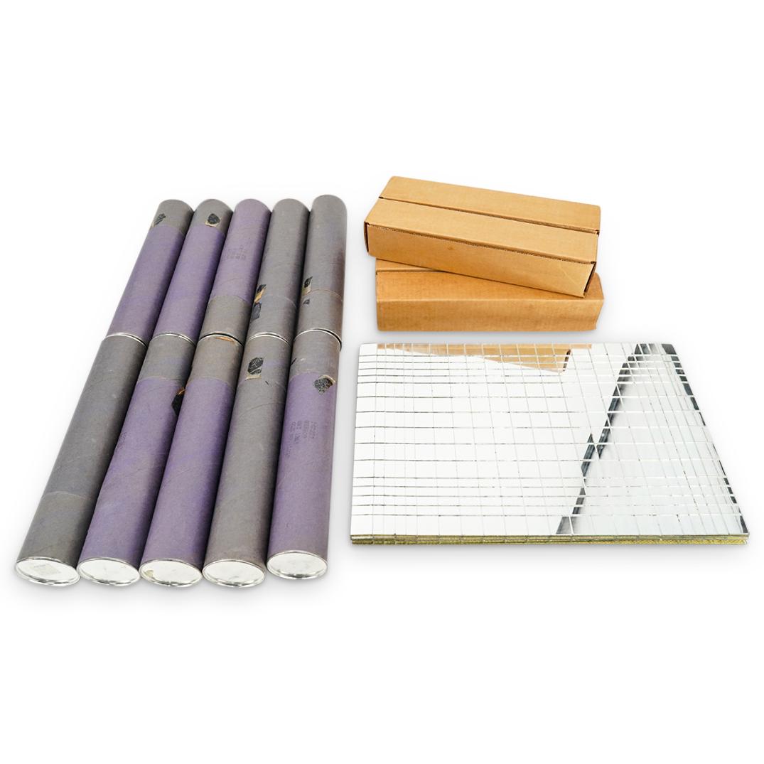 (16 Pc) Mirrored Table Placemats: DESCRIPTION: Sixteen placemats, each coated on topside with several square and rectangular mirror tiles. Fifteen pieces come in containers; sticker on top of cylindrical containers marked "Nessa Gaulo