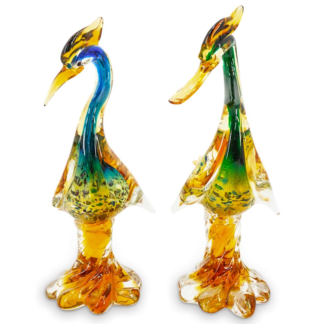 Pair of Murano Glass Heron Sculptures: DESCRIPTION: Murano glass sculptures of a herons with multicolor gradients as well as interior spotted design, details of plumes, wings and tail feathers atop amber spiraling bases. CIRCA: 20th Centur