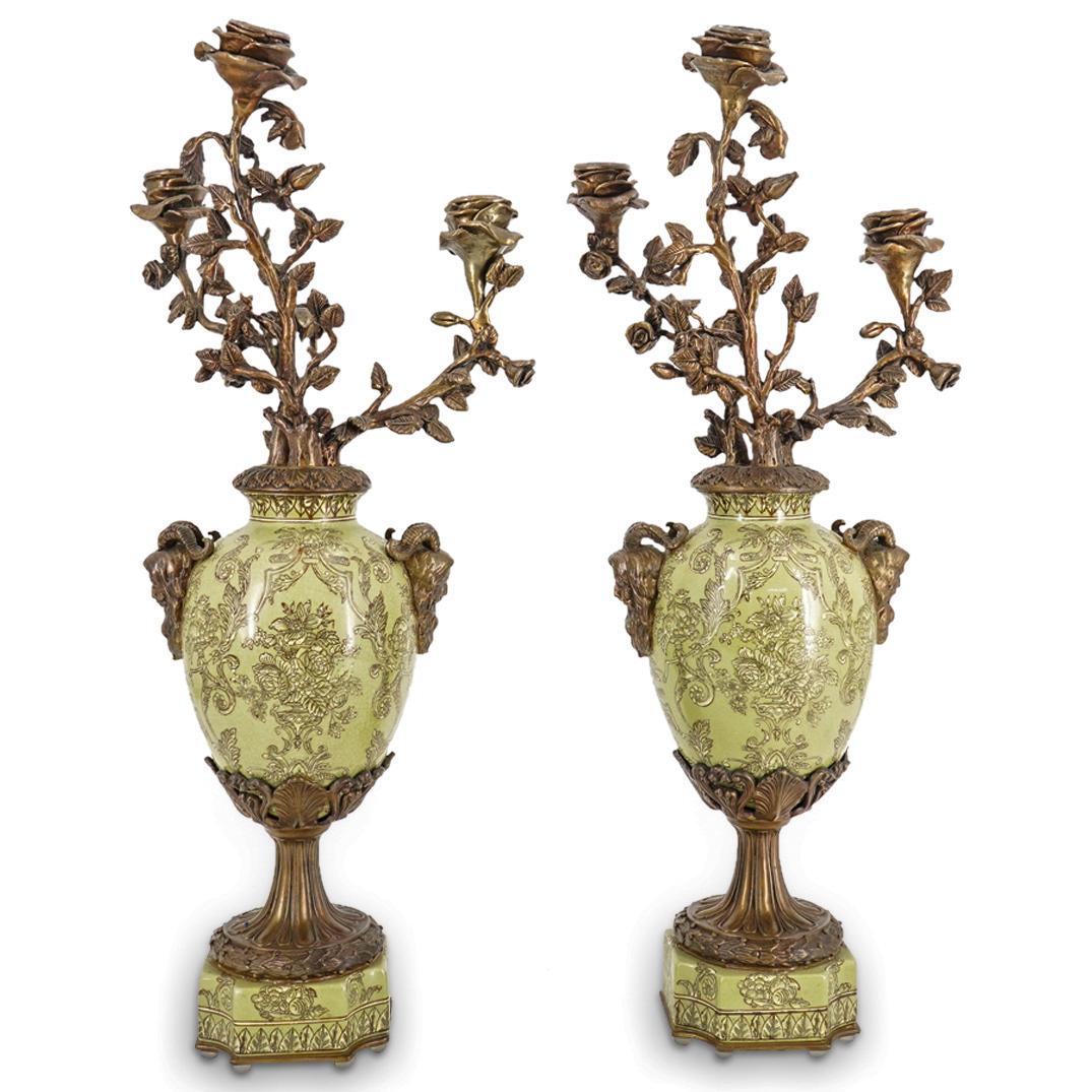 Pair Of Antique French Bronze And Enameled Porcelain Candelabra: DESCRIPTION: Two matching antique candelabras, each composed of a porcelain body supporting bronze rose branch form arms ending in a blossoming bobeche. Two anthropomorphic bearded heads with goats ho