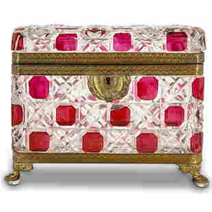 Antique Baccarat Cut Crystal And Dore Bronze Jewelry Box: DESCRIPTION: Baccarat cut crystal jewelry box featuring a textured exterior punctuated by ruby glass accents and embellished with dore bronze trimmings around lip and base. Piece stands on beast form