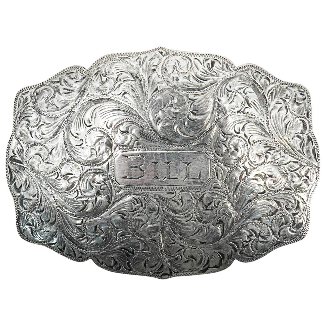 Wade's Silver Shop Sterling Silver Belt Buckle: DESCRIPTION: Wade's Silver Shop sterling silver belt buckle emblazoned "BILL" at the center surrounded by etched foliage designs. Marked on verso "WADE'S SILVER SHOP STERLING RENO". Total weight: 56.5