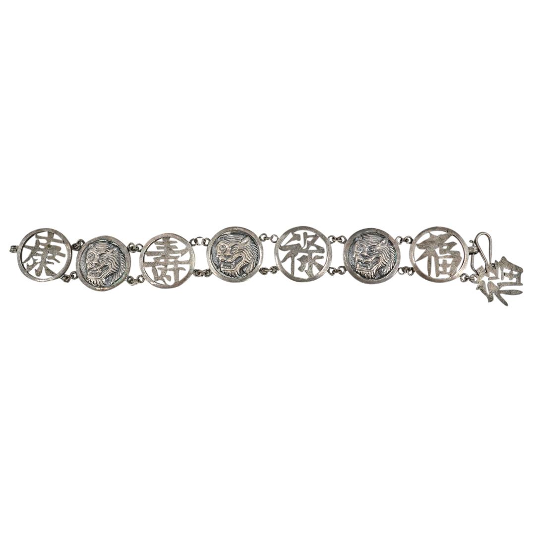 Antique Japanese Sterling Silver Tiger Emblem Bracelet: DESCRIPTION: An Antique Japanese sterling silver bracelet comprised of links featuring repousse Tiger decorations and open pierced calligraphy, completed with a hook clasp. CIRCA: Early 20th Century O