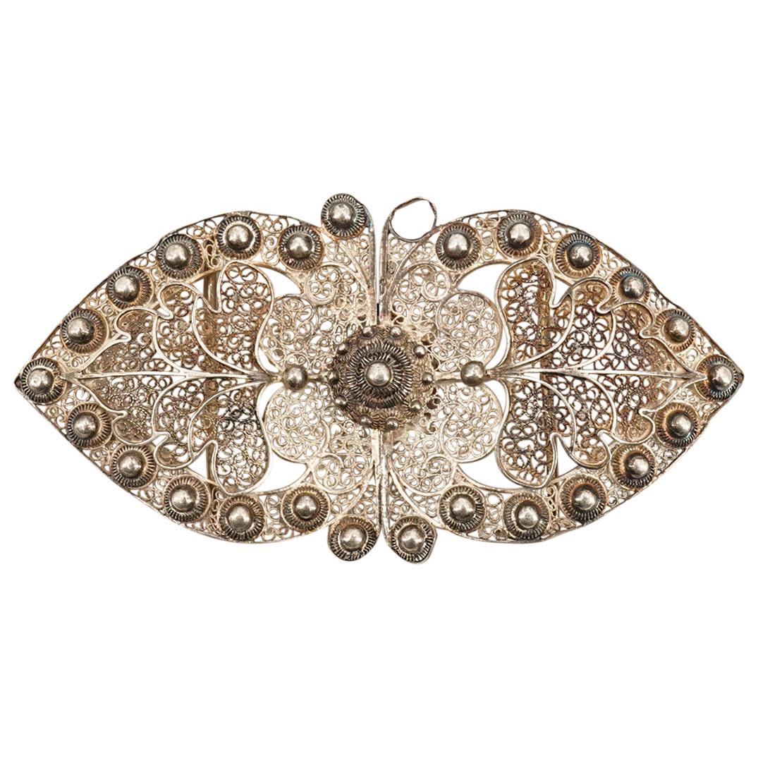 Antique Dutch Filigree Sterling Silver Belt Buckle: DESCRIPTION: Antique Dutch filigree Sterling silver belt buckle comprising of double leaf forms, with further leaf, scroll and bead designs at the interior. Impressed sword hallmark at the edge of one