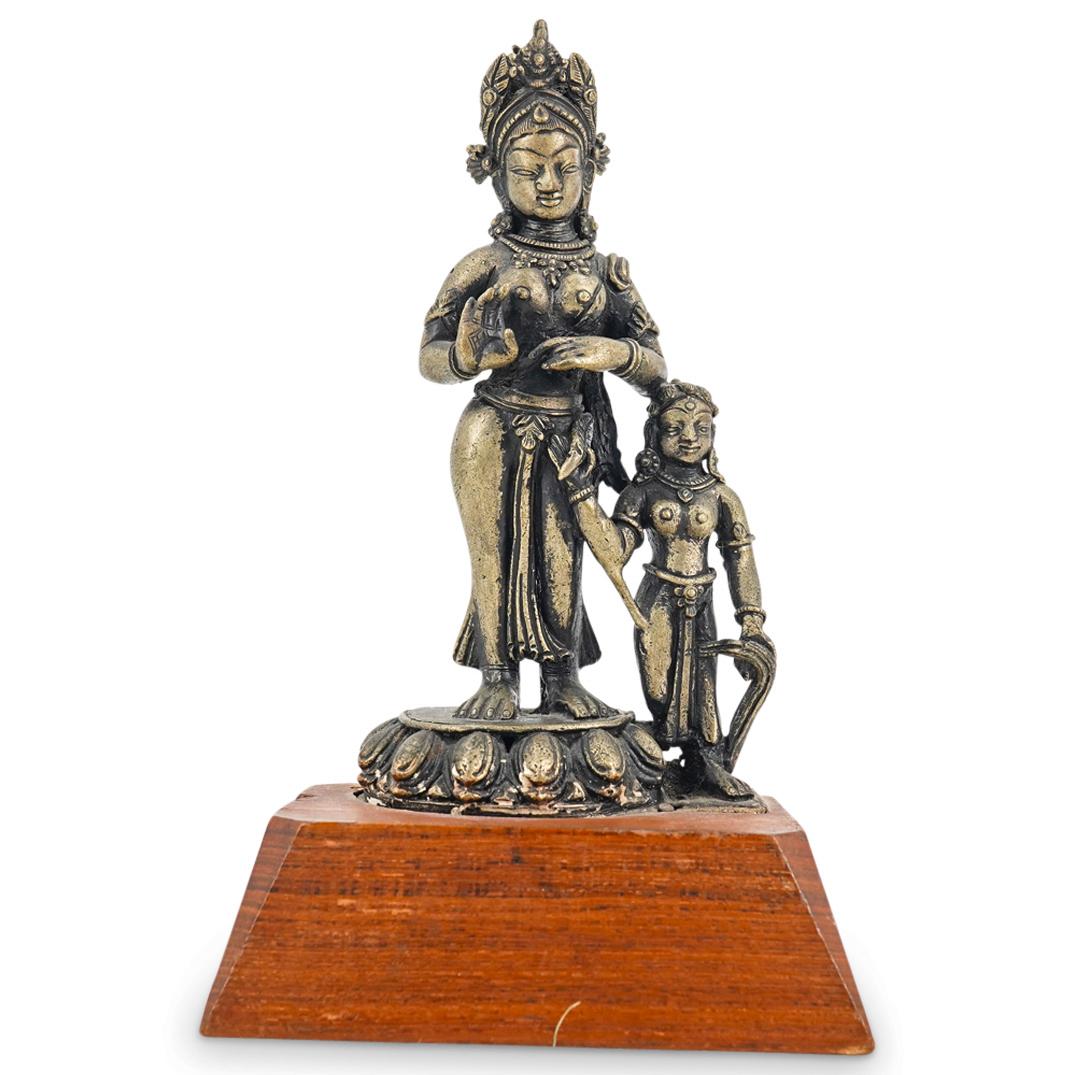 Antique Indian Bronze Hindu Goddess Bronze Grouping: DESCRIPTION: Antique Indian or Nepalese Hindu bronze sculpture depicting two partially nude standing female figures wearing jewelry. Mounted in a tapering wood base. CIRCA: Early 20th Century ORIGIN: 