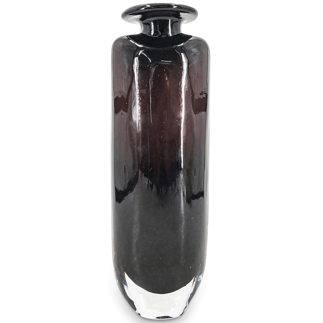 Kosta Boda Glass Vase: DESCRIPTION: A Kosta Boda glass vase with black and clear design, incised signature: "Kosta Boda" signed by artist. CIRCA: 20th Century ORIGIN: Sweden DIMENSIONS: H: 10.25" x D: 3.5" Have a similar it
